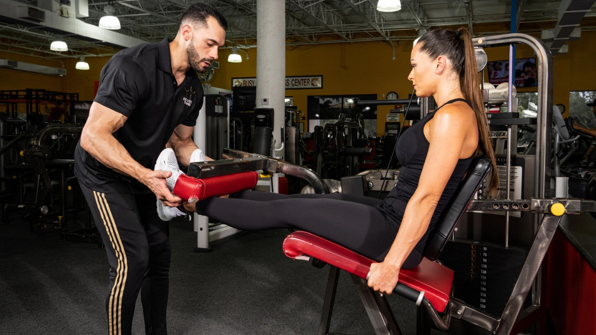 Dave Krasowski coaching a client through a leg curl at Wolf Gym