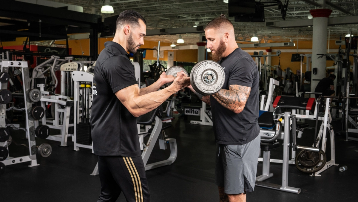 Dave Krasowski coaching a client on dumbbell curls